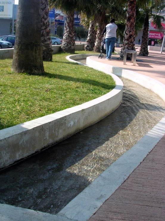 the sidewalk along the side of the road is very curved