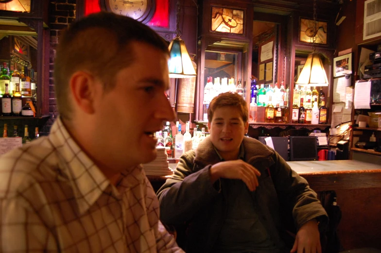 a man sits with another mans at a bar