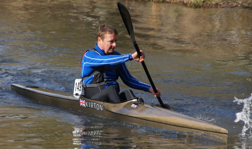 the man is kayaking down the river