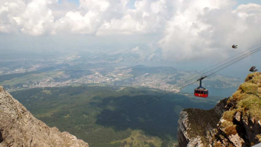 an aerial cable car with a mountain view behind it