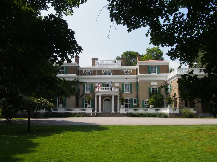 the large house with two large pillars has many windows and doors