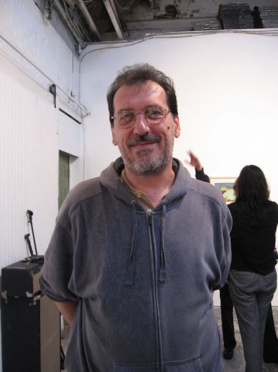 a smiling man in front of a white background