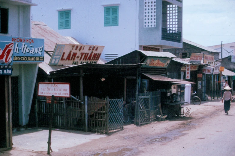 people walk down the street in an old asian village