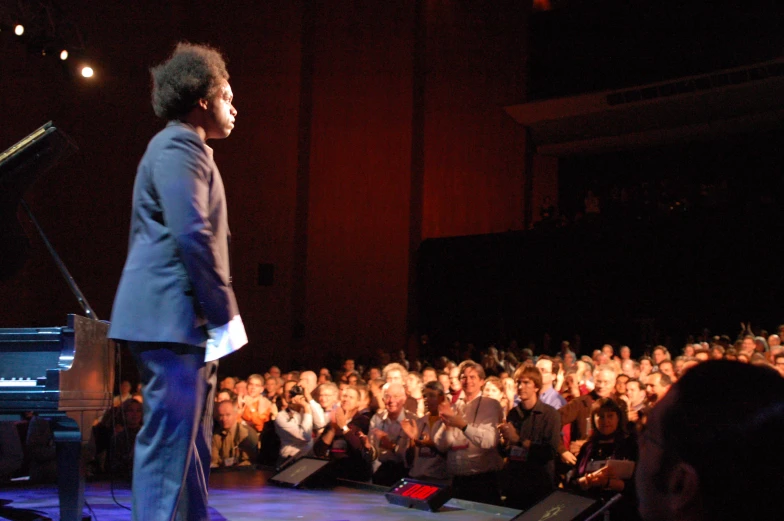 a man that is standing in front of a microphone