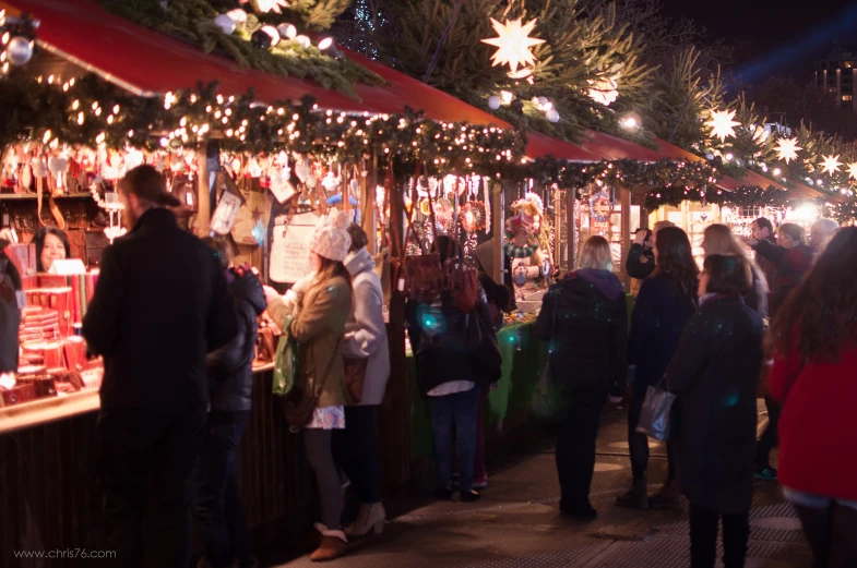 people standing in line at a market stall