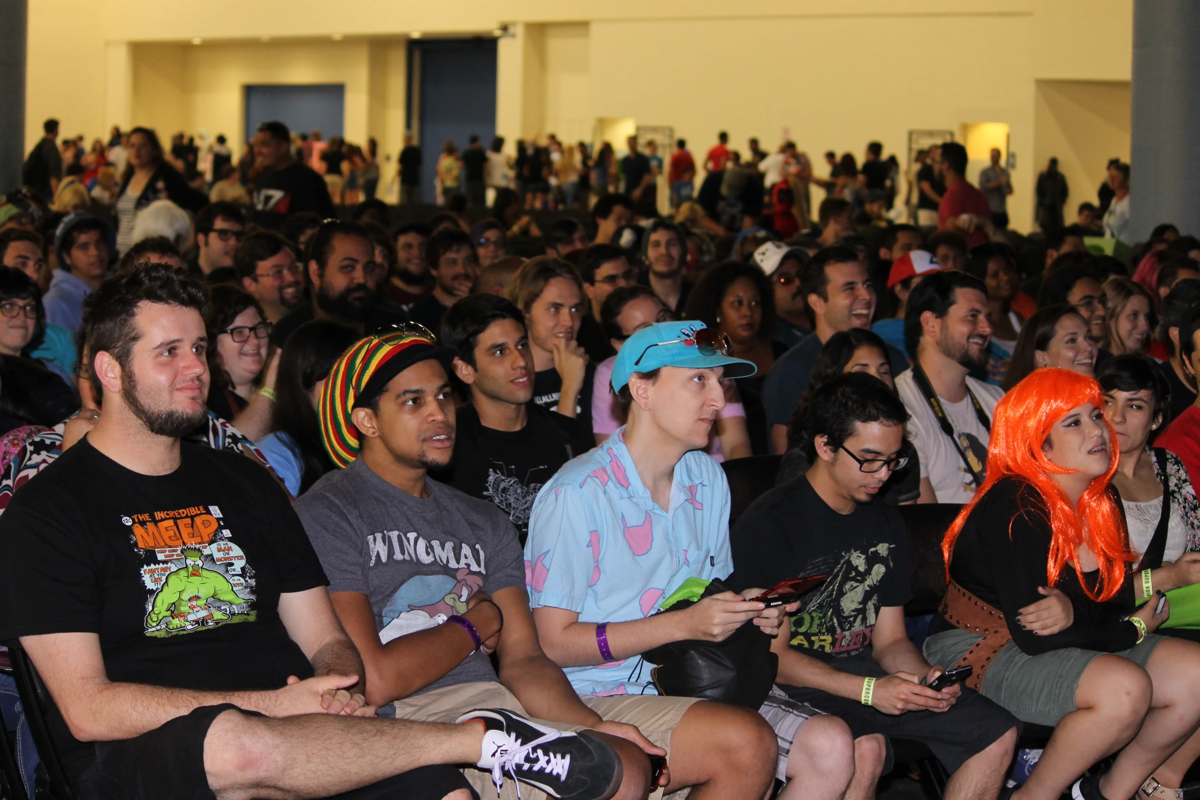 people in a large room with some listening