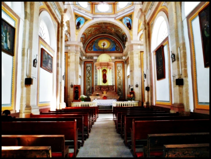 an interior po of an old church with pews