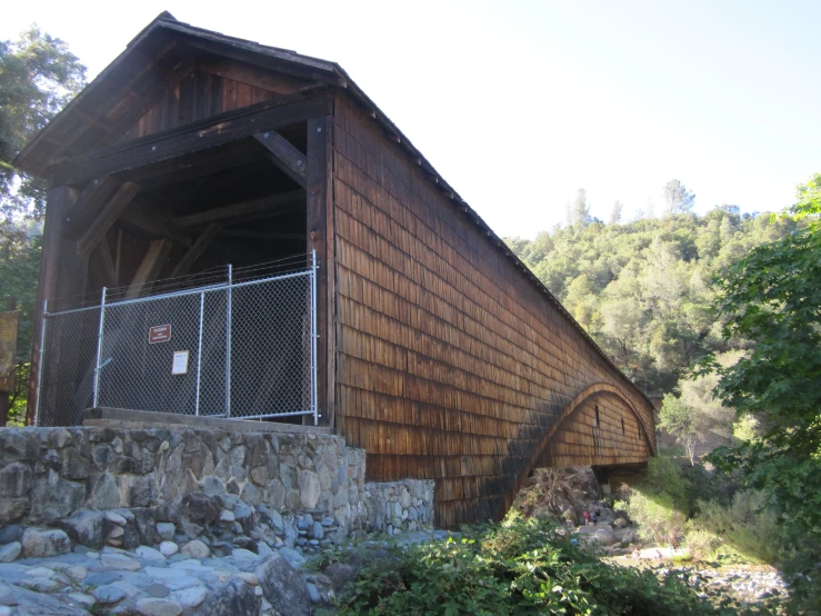 a wooden structure with a small bridge on the top