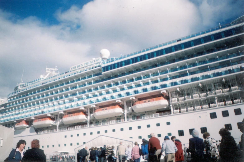 a large cruise ship docked next to a couple of people