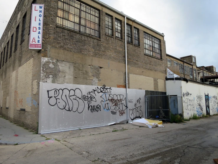 graffiti writing on the side of an old building