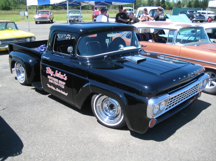 the vintage trucks are parked in a parking lot