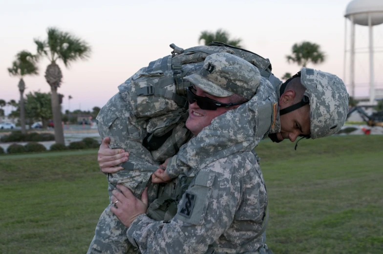 two people in uniform are hugging each other