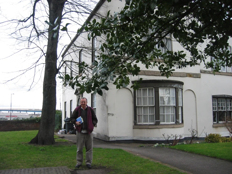 there is a man standing in front of the house