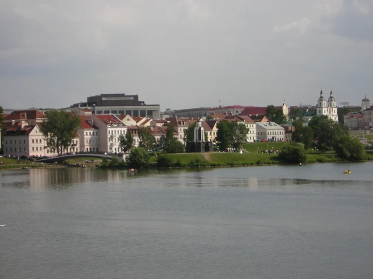 several white buildings on some water and trees