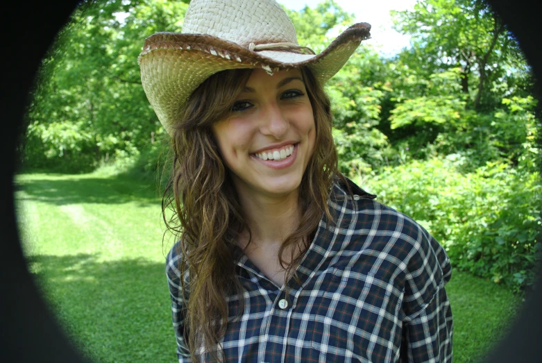 a woman is wearing a hat with long hair