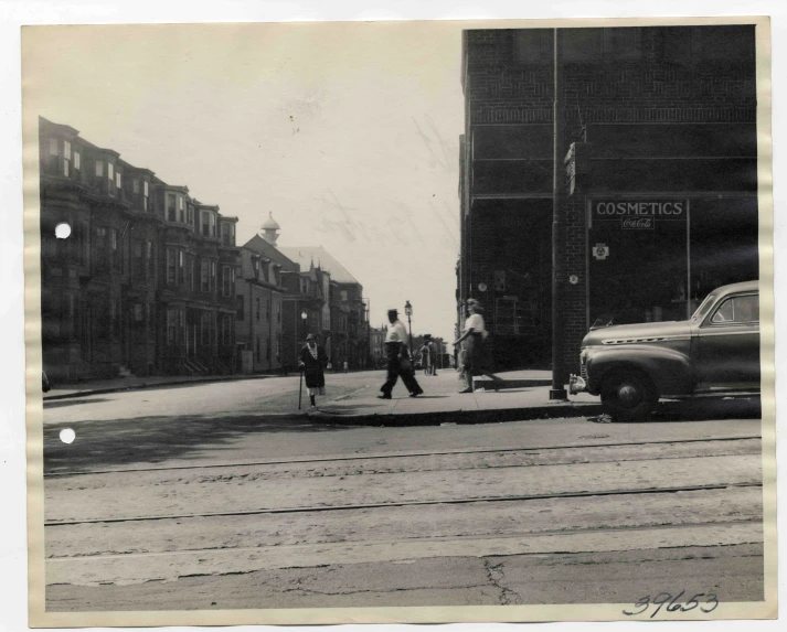 a black and white po with a man on the sidewalk walking past