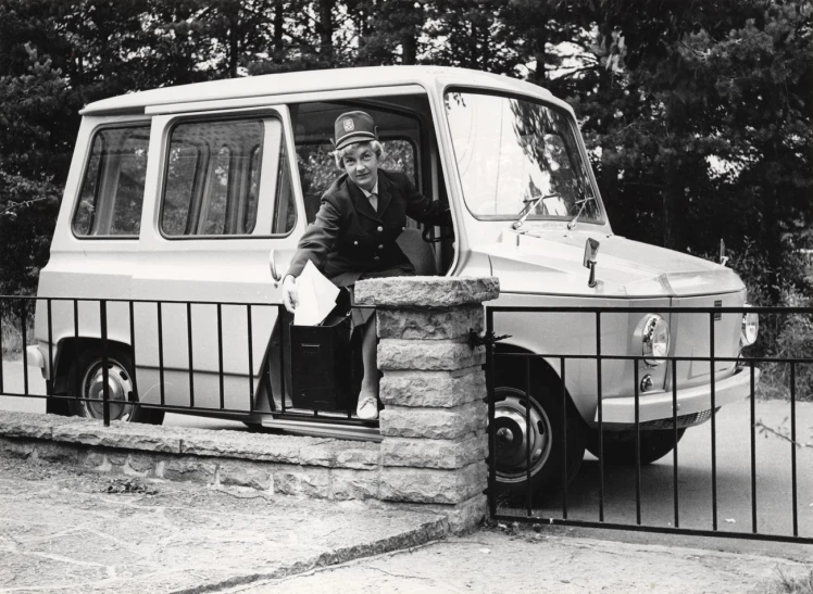 a man is in a van driving down the street