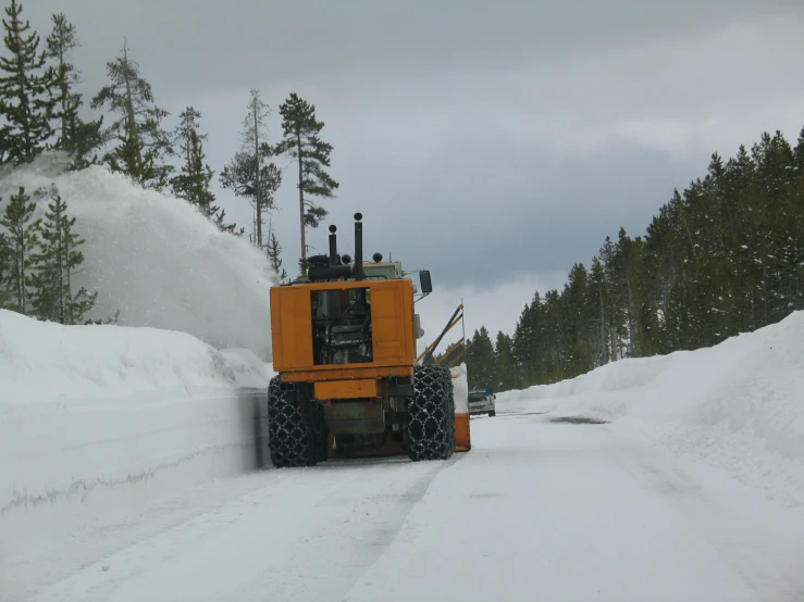 a snowplow digging through the deep snow