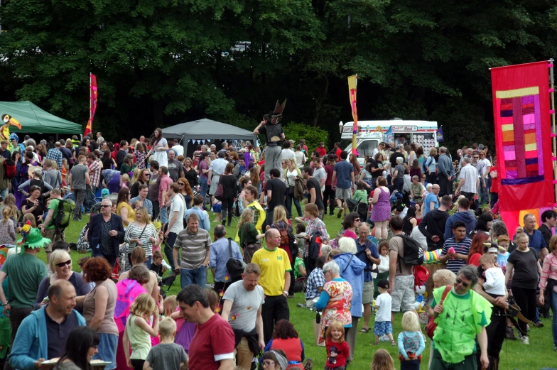 a large group of people standing around a colorfully decorated field