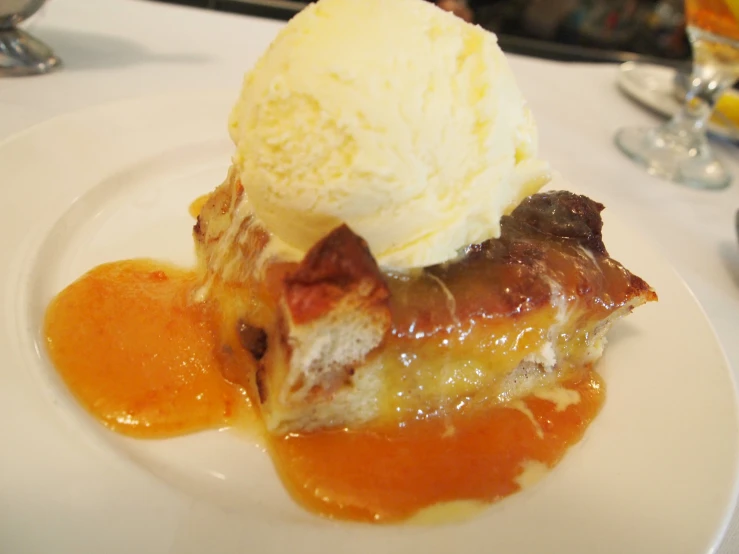 a slice of pie with ice cream on a white plate