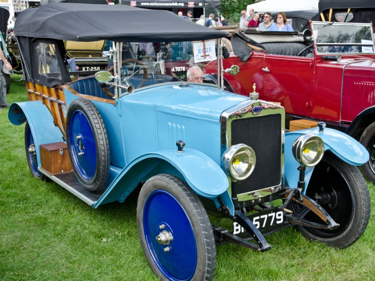 a classic car parked in a field while on display