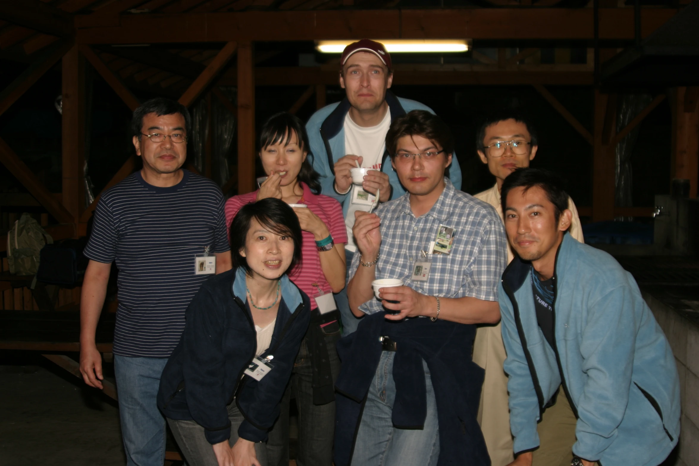 a bunch of people holding cups posing for the camera