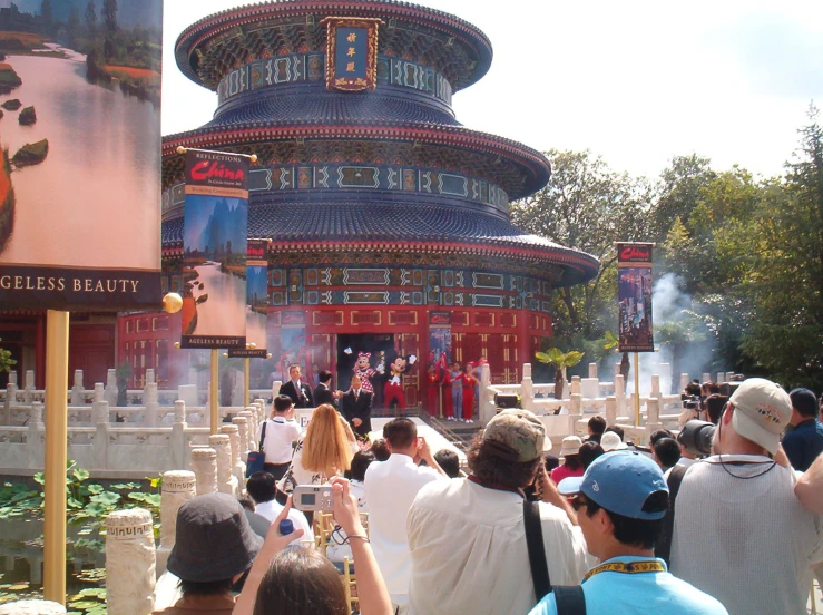 a large crowd gathers in front of a building