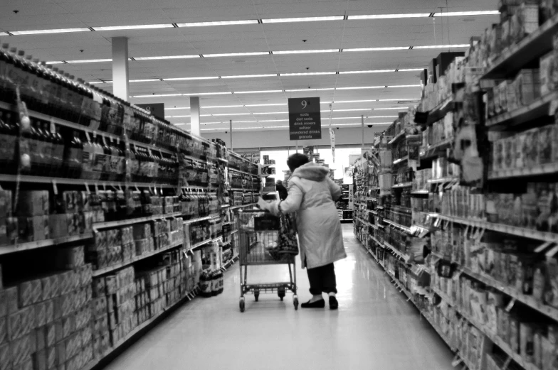 woman shopping in a supermarket aisle