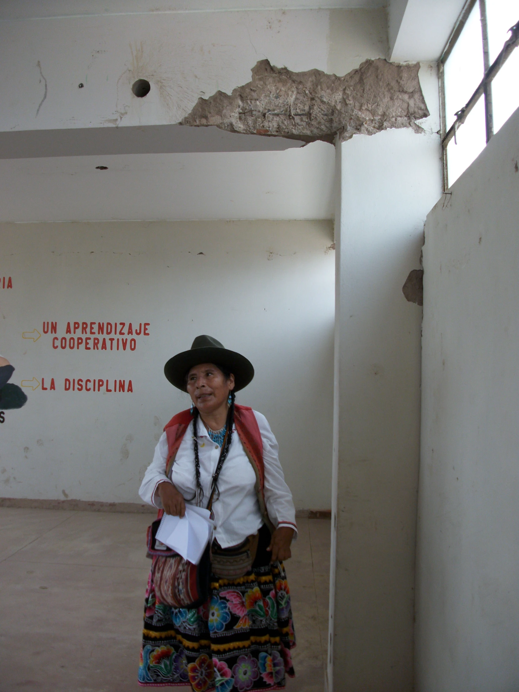 a woman in traditional mexican dress is walking towards the camera