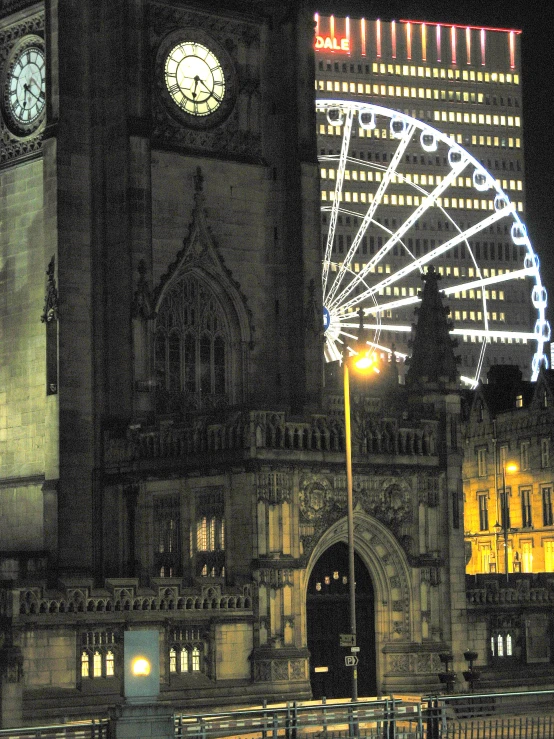 a city at night with a ferris wheel and buildings in the background