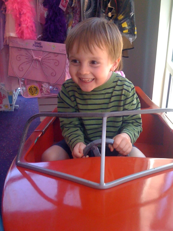 a  playing on a toy speed car