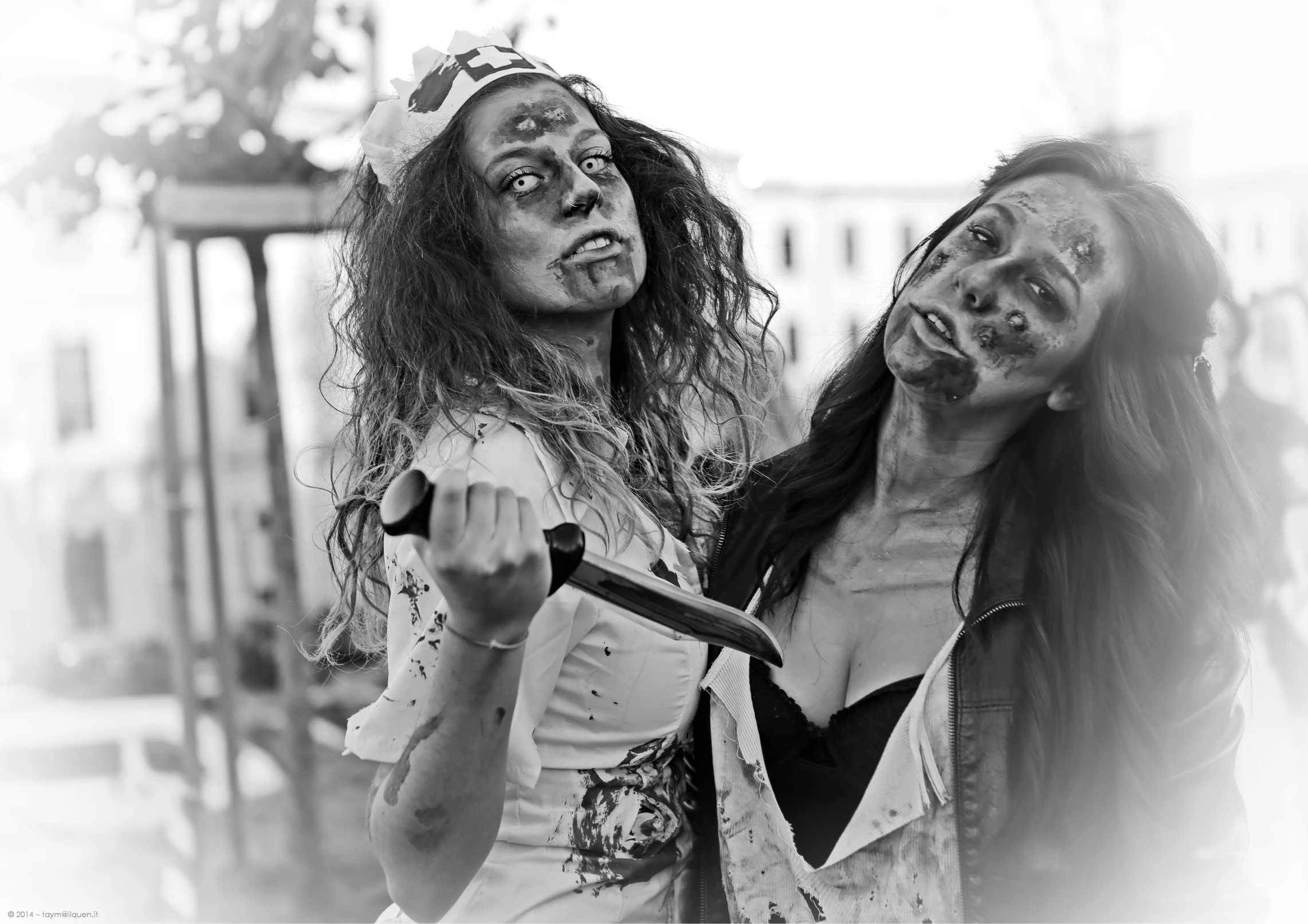 two girls with long hair are holding soing while wearing costumes