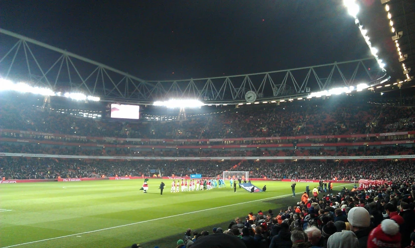 an empty stadium at night with fans and other people