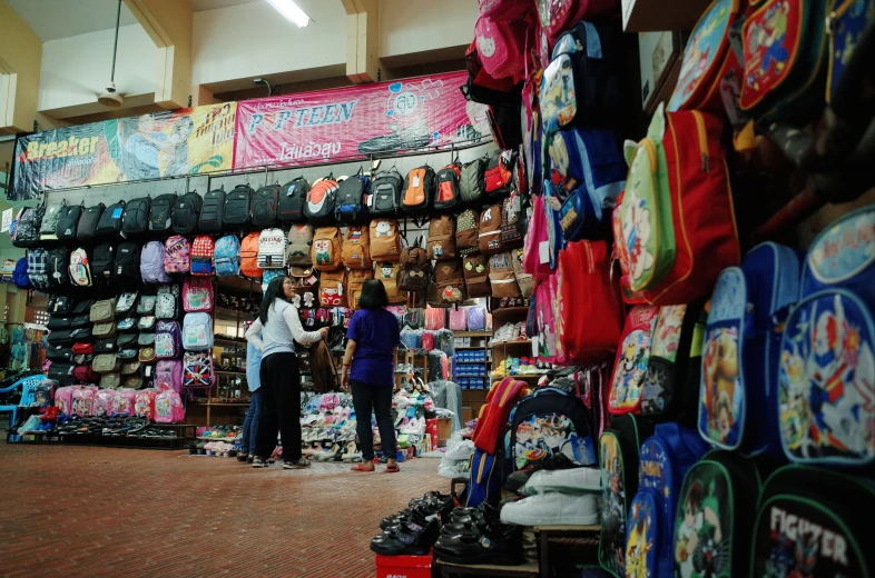 a couple of people that are standing in a market