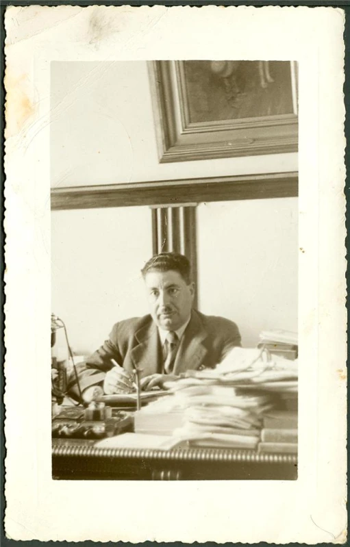 a man is in front of an assortment of work papers