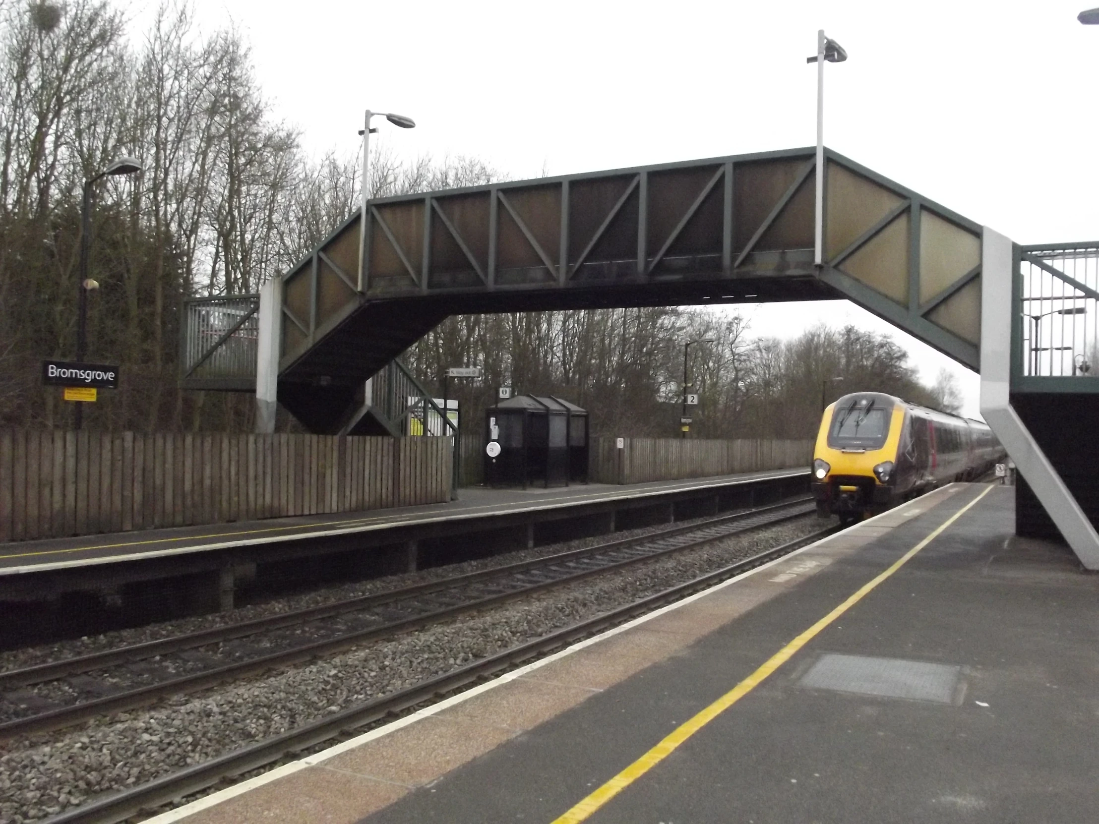 an empty train station with a train on the tracks