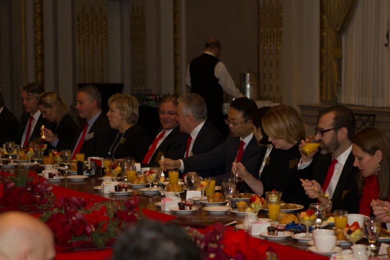 a group of people in business attire at a table