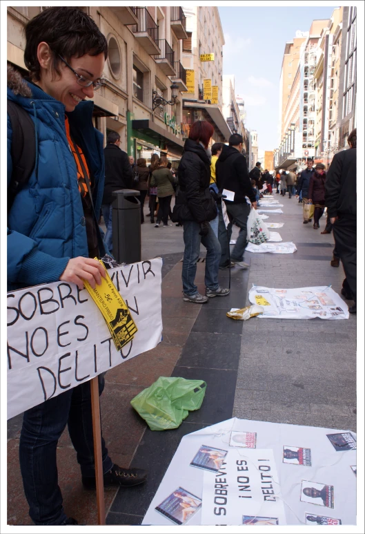people walking on the side walk holding banners
