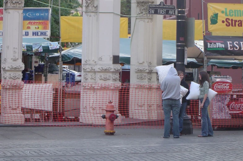 people talking on a city sidewalk next to buildings