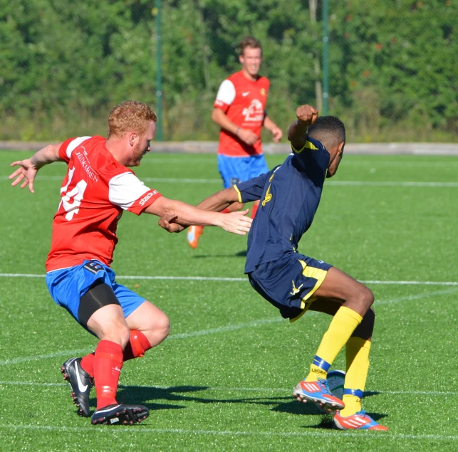 two soccer players fight for the ball during a game