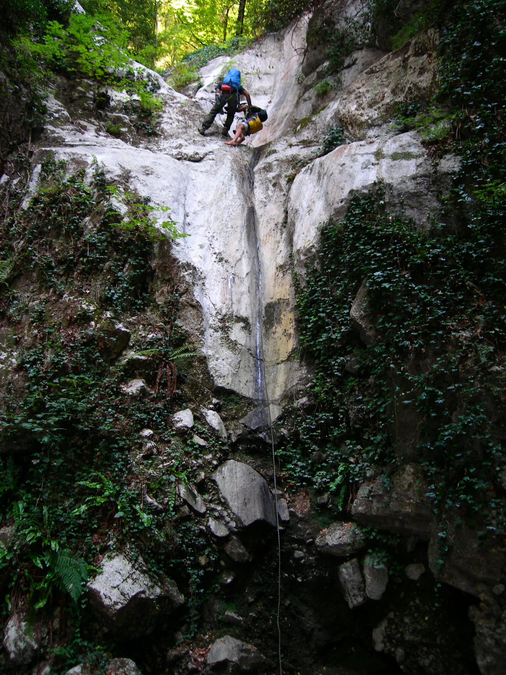 a man riding a motorcycle over a stone falls