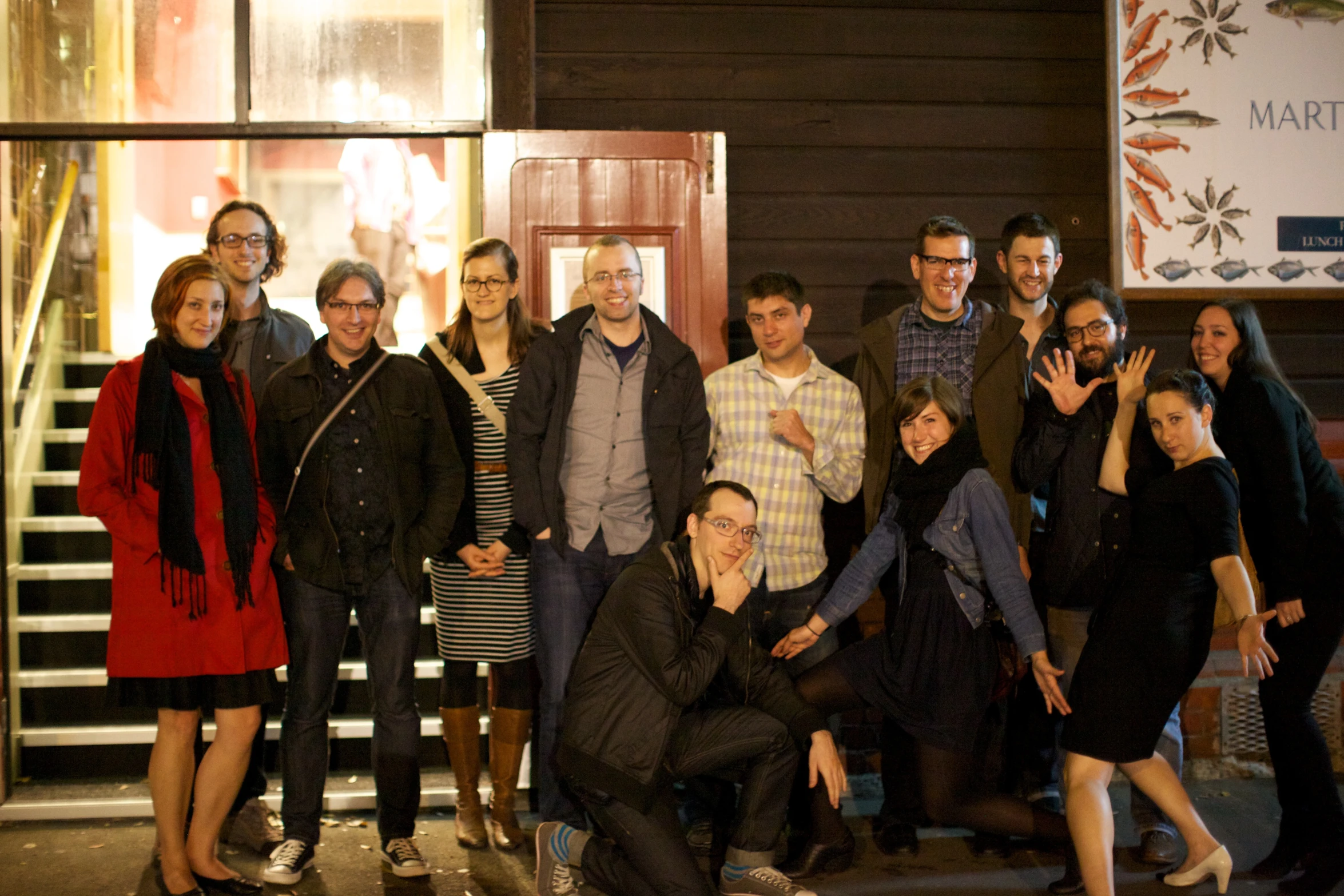 a group of people posing in front of a building