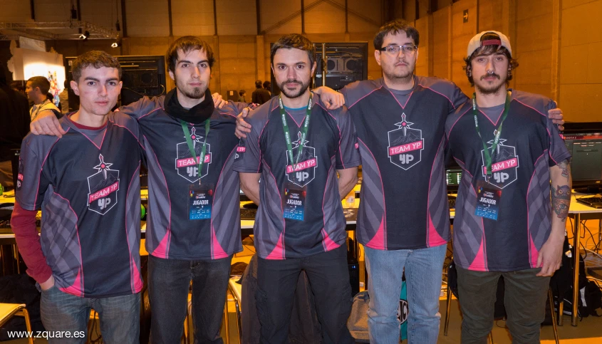 four men standing side by side with some badges on their shirts