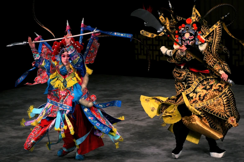 two women with various types of costumes perform an oriental dance