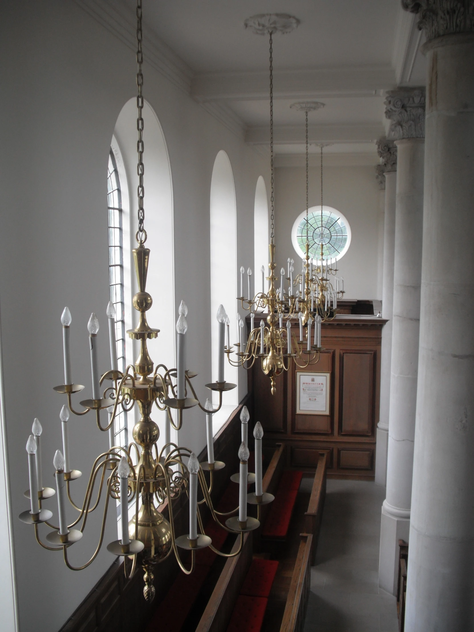 a church with chandeliers and a pews