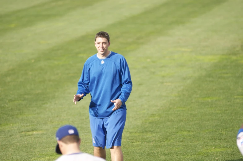 a person wearing a blue uniform walking in the grass