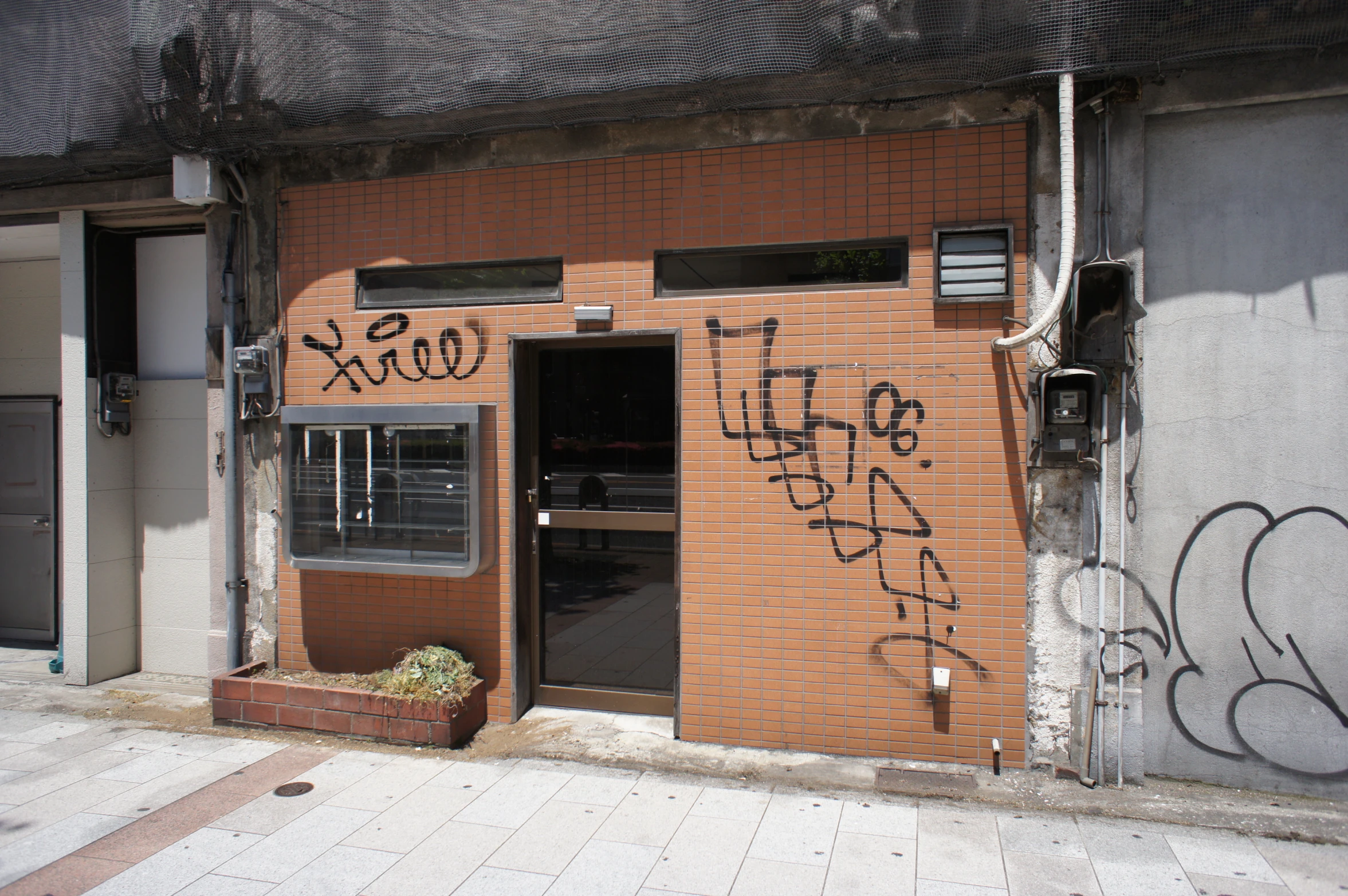 the entrance to a building with graffiti written on it