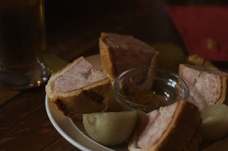 two glasses and four pieces of meat on a plate