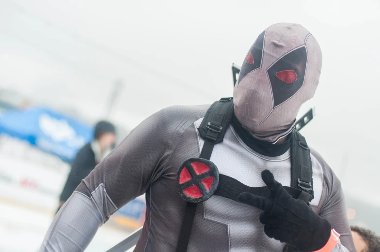 man in grey and red bodysuit carrying backpack