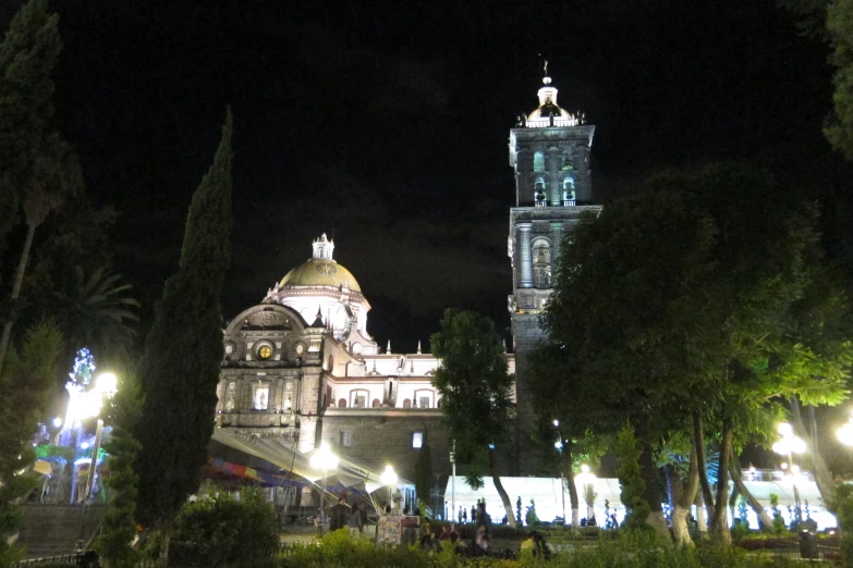 a big building with a tower that is lit up at night